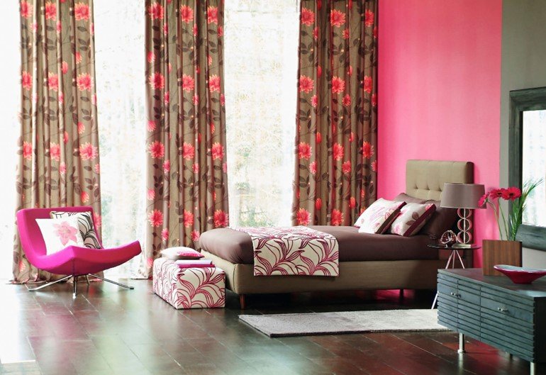 Bedroom styled with bold floral patterned curtains in Austin, TX
