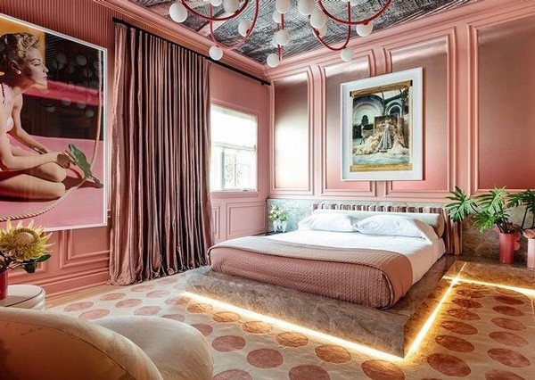 Luxury bedroom featuring pink silk drapery panels in Austin, TX